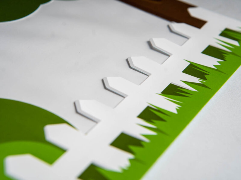 Up close shot of an illustrated fence and grass on an envelope