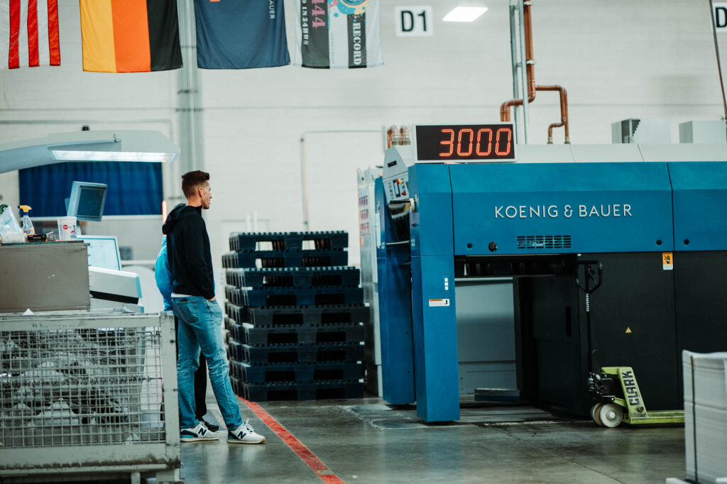 Two men working in envelope production warehouse